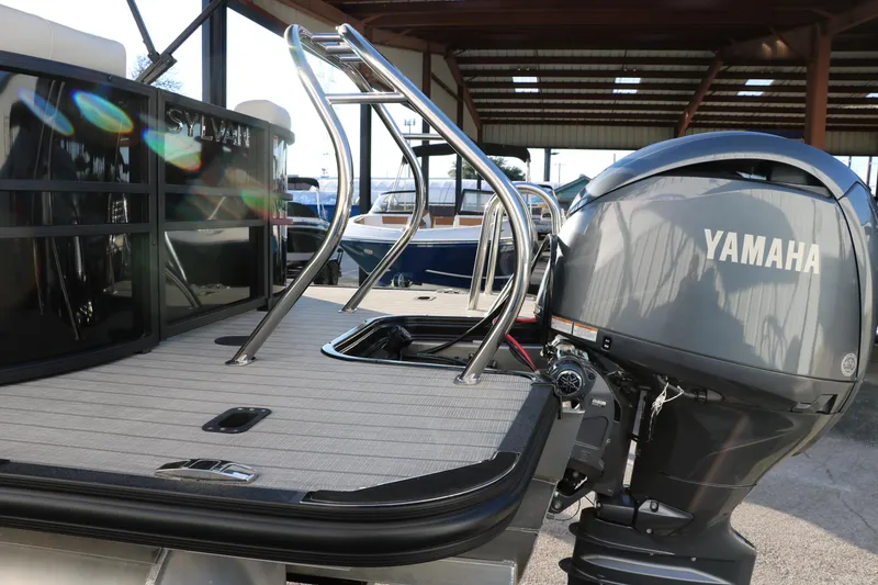 Slide: The Image of 2025 Sylvan Mirage X1 boat with Yamaha outboard motor, docked under a covered structure. - 5