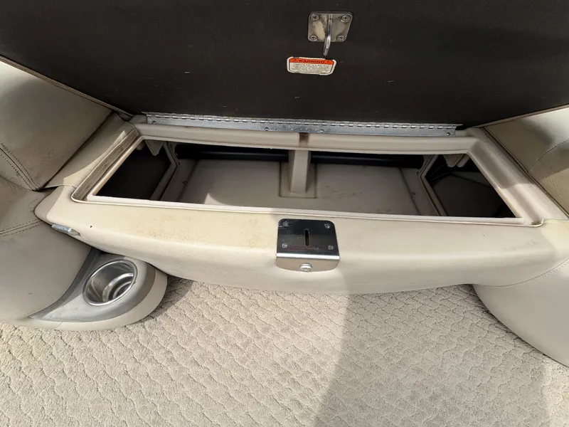 Slide: The Image of Open storage compartment on 2011 Sun Tracker PARTY BARGE 25 boat, featuring beige interior. - 11