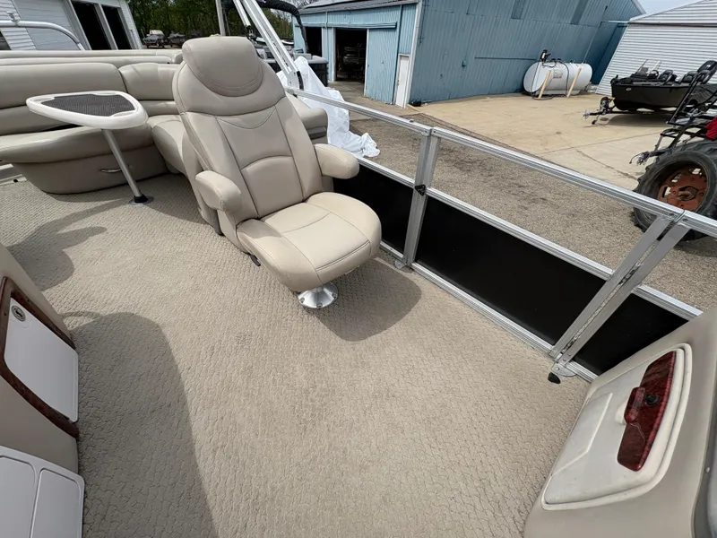 Slide: The Image of 2011 Sun Tracker PARTY BARGE 25 interior with beige seating and carpet. - 12