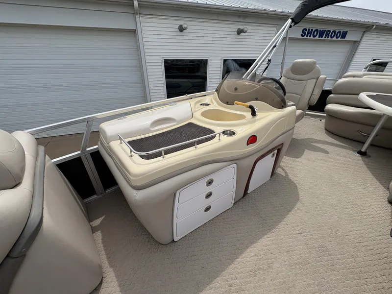 Slide: The Image of 2011 Sun Tracker PARTY BARGE 25 interior with helm and seating area. - 16