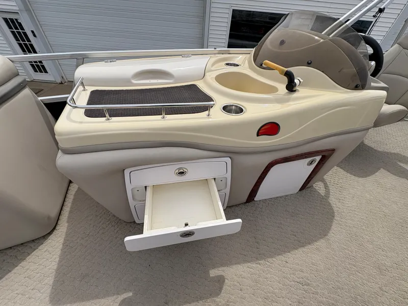 Slide: The Image of 2011 Sun Tracker PARTY BARGE 25 boat console with storage drawer open. - 17