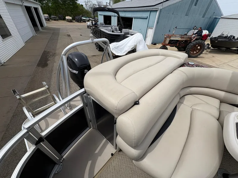 Slide: The Image of 2011 Sun Tracker PARTY BARGE 25 with beige seating and Mercury outboard motor. - 26