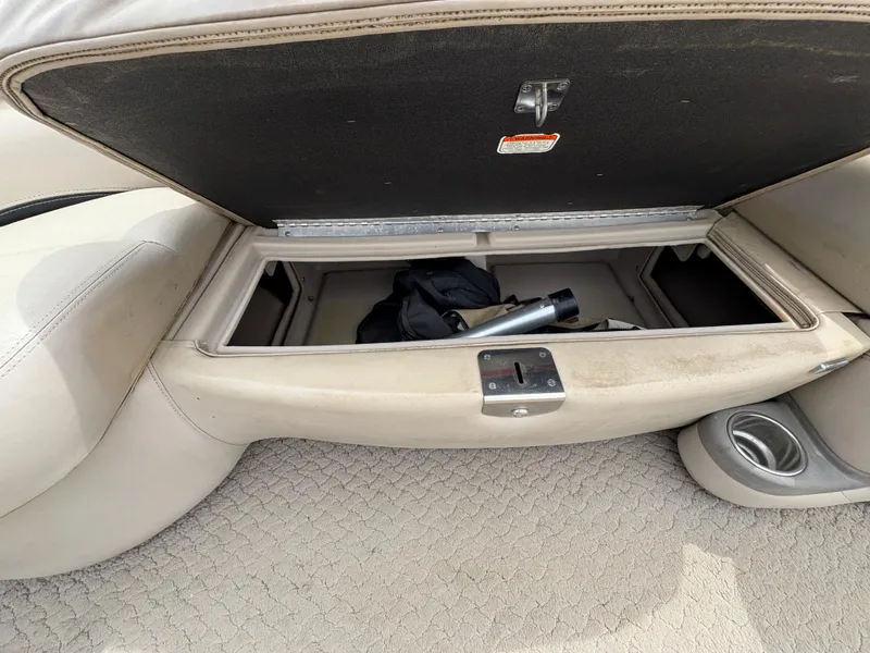 Slide: The Image of Open storage compartment in 2011 Sun Tracker PARTY BARGE 25 boat, showing interior items. - 9