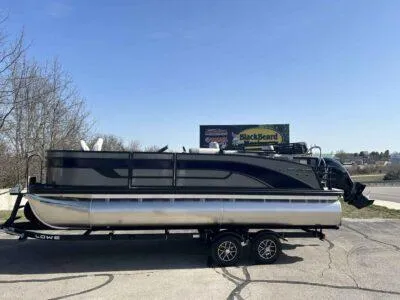 Slide: The Image of 2025 Lowe SF 214 pontoon boat on trailer, parked outdoors. - 10