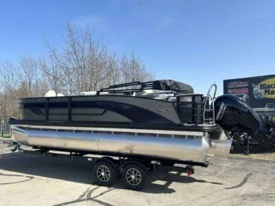 Slide: The Image of 2025 Lowe SF 214 pontoon boat on trailer, parked outdoors under clear sky. - 5