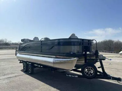 Slide: The Image of 2025 Lowe SF 214 pontoon boat on trailer under clear blue sky. - 6