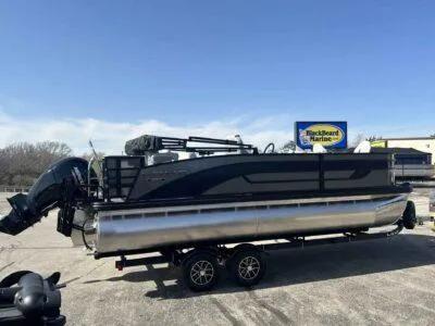 Slide: The Image of 2025 Lowe SF 214 pontoon boat on trailer in parking lot, clear sky background. - 8