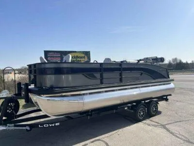 Slide: The Image of 2025 Lowe SF 214 pontoon boat on trailer under clear blue sky. - 9