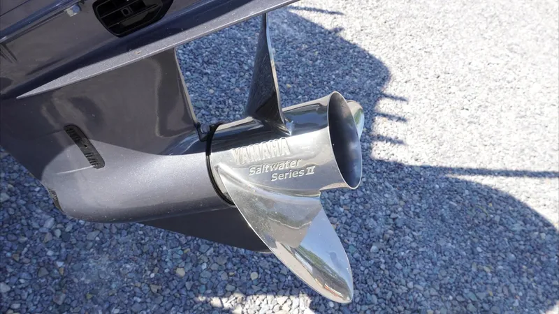 Slide: The Image of 2025 Tidewater 2300 Carolina Bay boat with Yamaha outboard motor on gravel surface. - 11