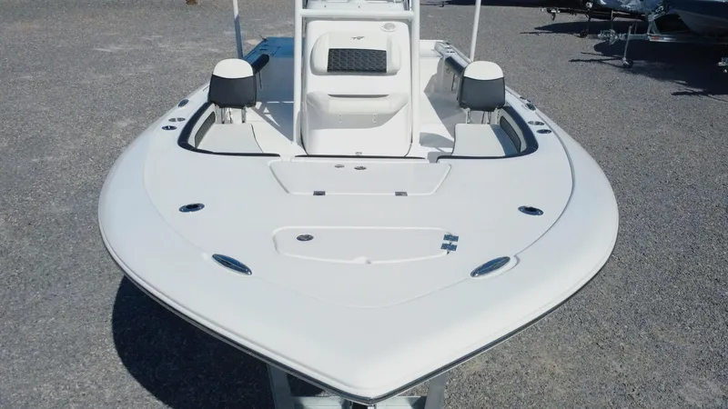 Slide: The Image of 2025 Tidewater 2300 Carolina Bay boat with Yamaha engine, blue hull, and fishing rod holders. - 12