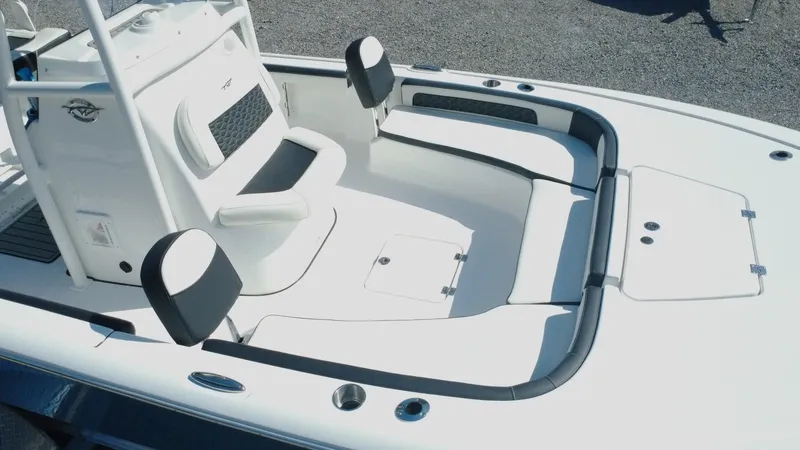 Slide: The Image of 2025 Tidewater 2300 Carolina Bay boat dashboard with Simrad display and steering wheel. - 5