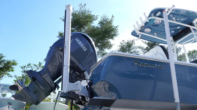 Slide: The Image of 2025 Tidewater 2300 Carolina Bay boat interior with seating and console, displayed on gravel surface. - 9