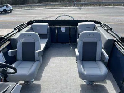Slide: The Image of 2025 Lowe LS 230 WT boat interior with four gray seats on a sunny day. - 8