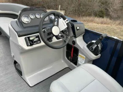 Slide: The Image of 2025 Lowe LS 210 WT boat dashboard with steering wheel and control panel. - 10