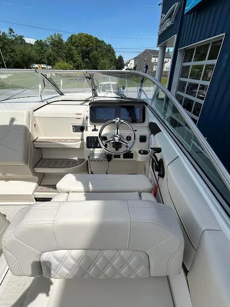 Slide: The Image of 2024 Regal 26 XO boat interior with modern dashboard and steering wheel. - 2