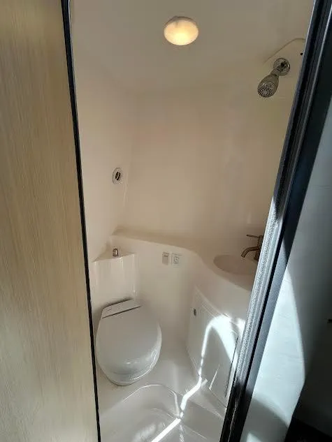 Slide: The Image of 2024 Regal 26 XO boat bathroom with toilet and shower, compact and modern design. - 8