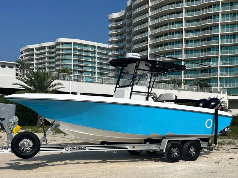 Slide: The Image of 2006 Fountain 23 Tournament CC boat on trailer, with modern buildings in the background. - 1