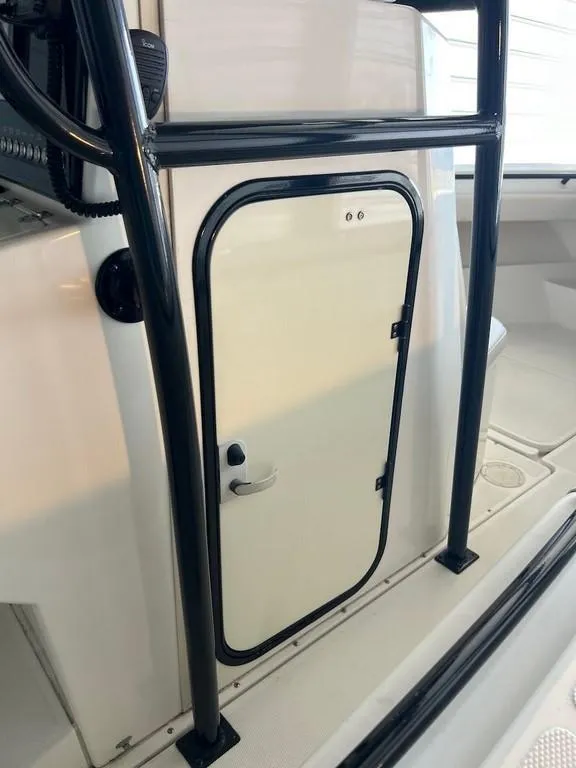 Slide: The Image of 2006 Fountain 23 Tournament CC boat console with black frame and white door. - 13