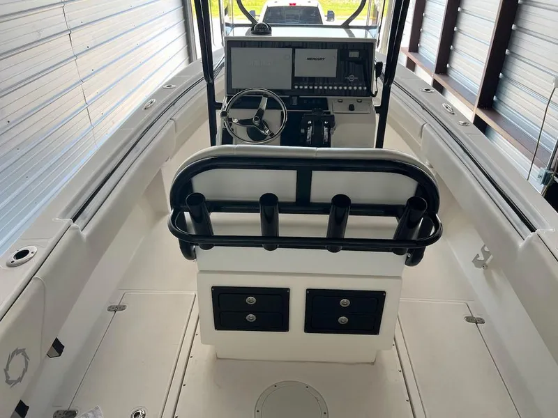Slide: The Image of 2006 Fountain 23 Tournament CC boat interior with steering console and storage compartments. - 2