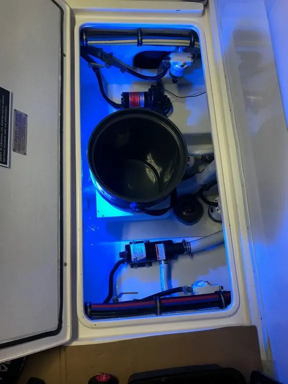 Slide: The Image of 2006 Fountain 23 Tournament CC boat compartment with blue lighting and mechanical components. - 5