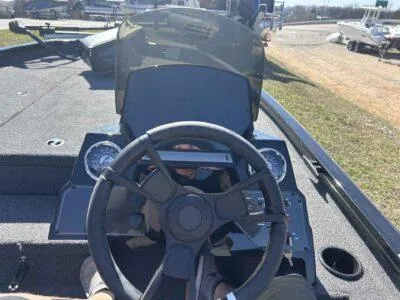 Slide: The Image of 2025 Lowe Stinger 195 Bass boat dashboard with steering wheel and gauges. - 8