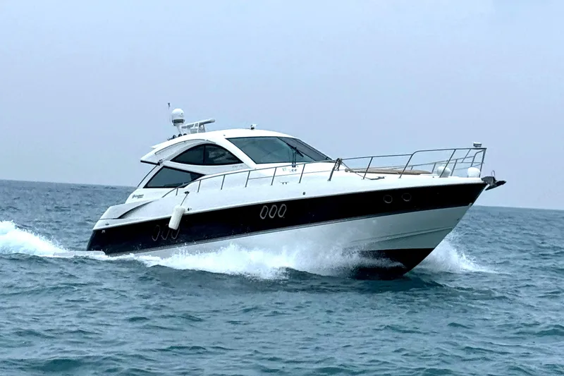 The Image of 2014 Cruisers Yachts 54 Sport Coupe cruising on open water. - 0