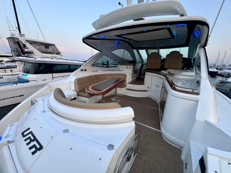 Slide: The Image of 2014 Cruisers Yachts 54 Sport Coupe, luxury interior, docked at marina, elegant seating and design. - 19