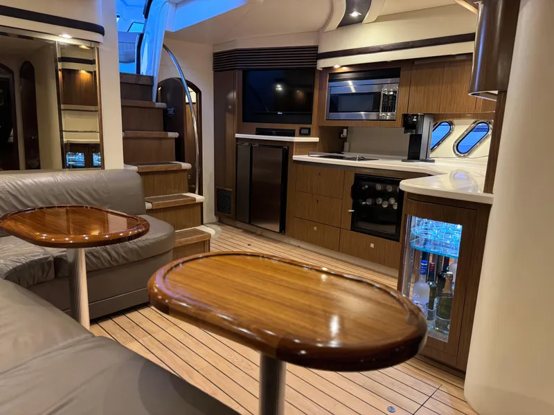 Slide: The Image of Luxurious interior of 2014 Cruisers Yachts 54 Sport Coupe with modern kitchen and seating area. - 24