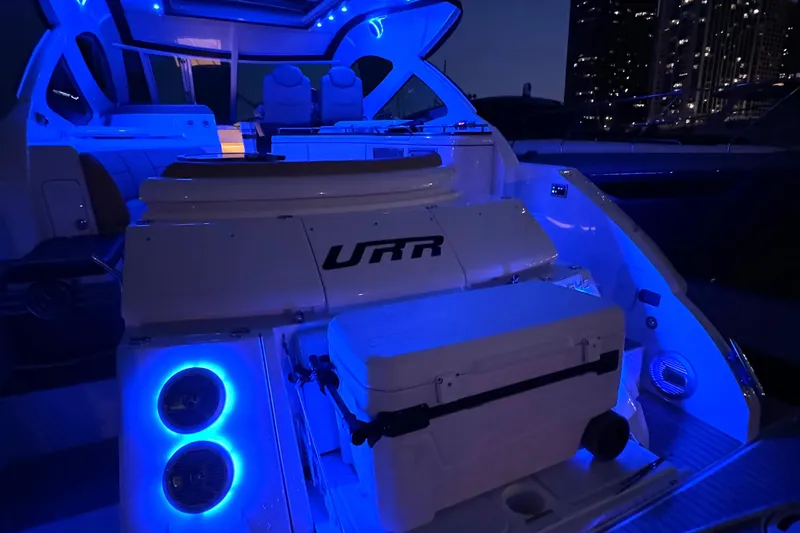 Slide: The Image of 2014 Cruisers Yachts 54 Sport Coupe with blue LED lighting at night. - 29