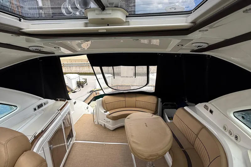 Slide: The Image of Interior of 2014 Cruisers Yachts 54 Sport Coupe with tan seating and skylight. - 40
