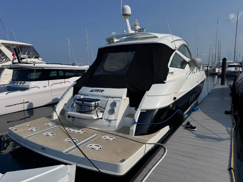 Slide: The Image of 2014 Cruisers Yachts 54 Sport Coupe docked at marina, rear view. - 5