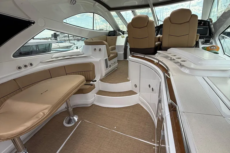 Slide: The Image of 2014 Cruisers Yachts 54 Sport Coupe interior with luxurious seating and modern helm. - 51