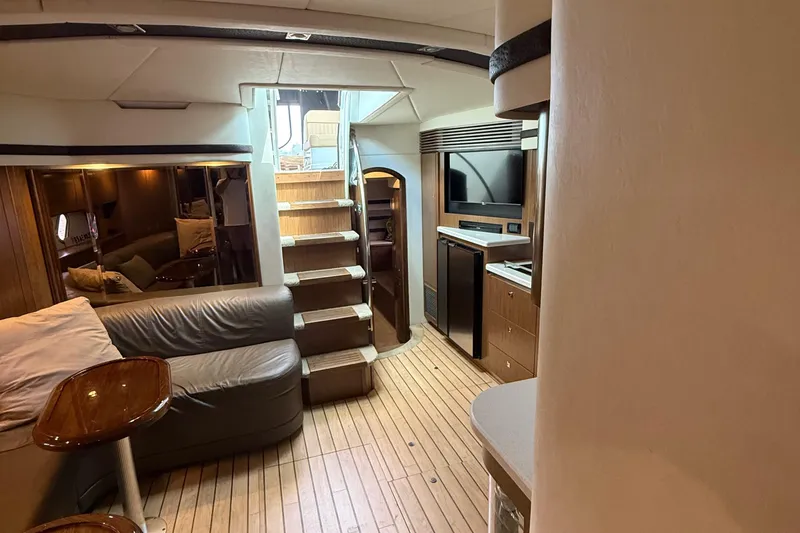 Slide: The Image of Interior of 2014 Cruisers Yachts 54 Sport Coupe with modern furnishings and wooden flooring. - 52