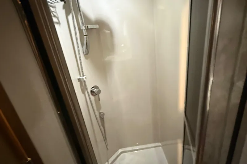Slide: The Image of Shower area inside 2014 Cruisers Yachts 54 Sport Coupe, featuring modern fixtures. - 56
