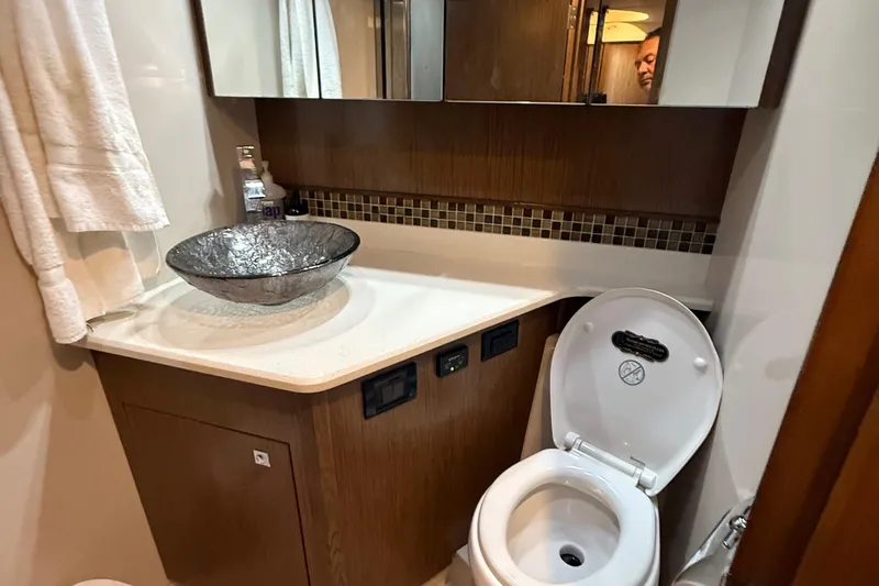 Slide: The Image of Luxurious bathroom in 2014 Cruisers Yachts 54 Sport Coupe with modern glass sink. - 57