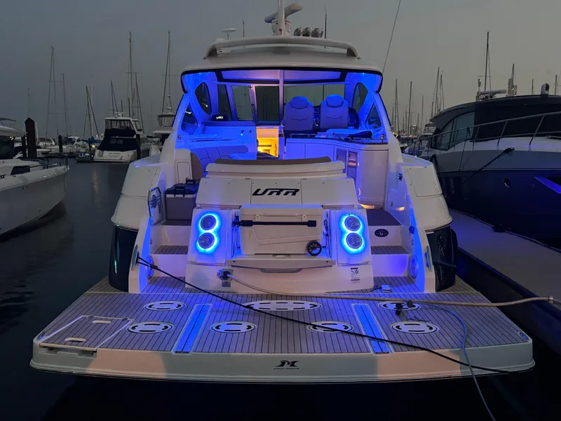 Slide: The Image of 2014 Cruisers Yachts 54 Sport Coupe with blue LED lights at marina. - 10
