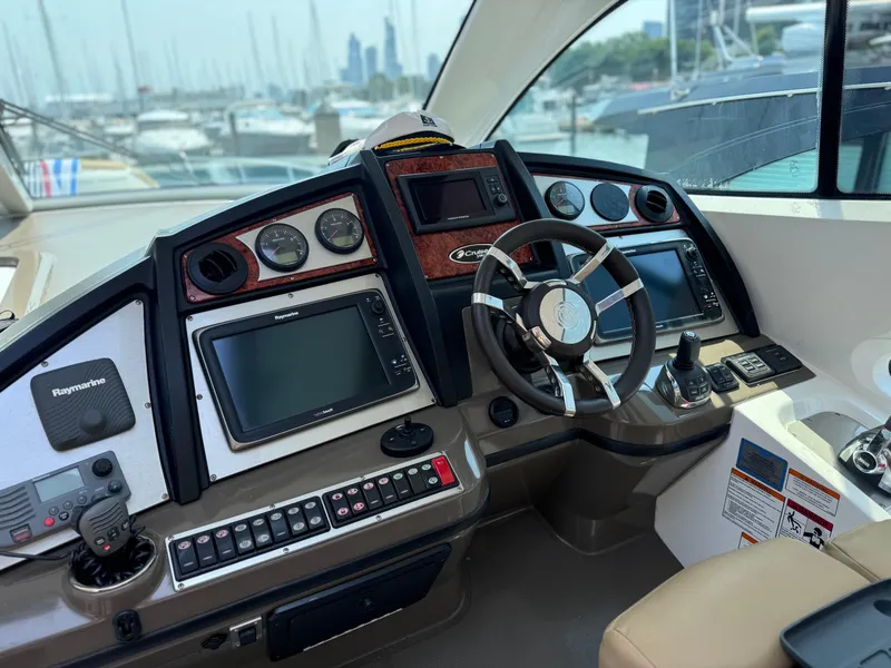 Slide: The Image of 2014 Cruisers Yachts 54 Sport Coupe helm with advanced navigation systems and luxurious design. - 12