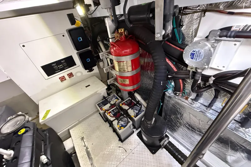Slide: The Image of Engine room of 2014 Cruisers Yachts 54 Sport Coupe with fire extinguisher and battery setup. - 36