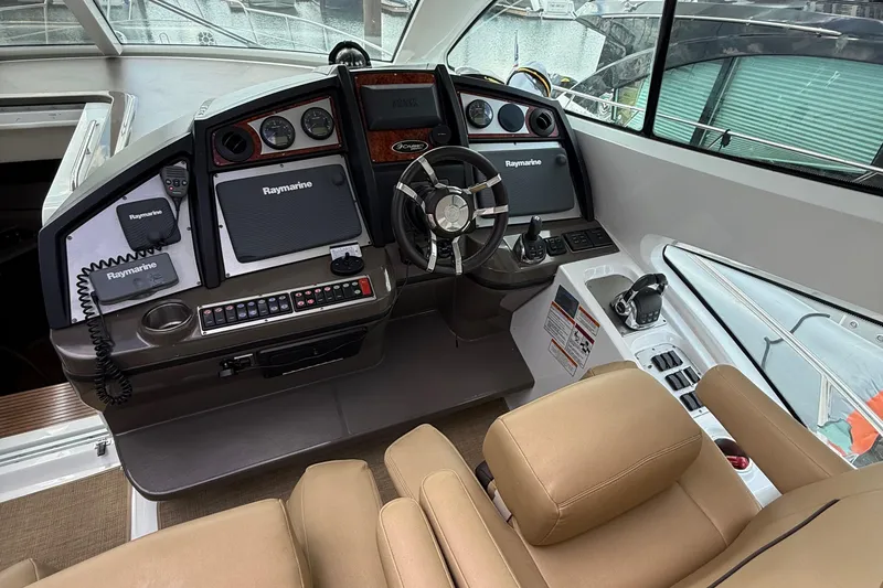 Slide: The Image of 2014 Cruisers Yachts 54 Sport Coupe helm with Raymarine electronics and leather seating. - 39