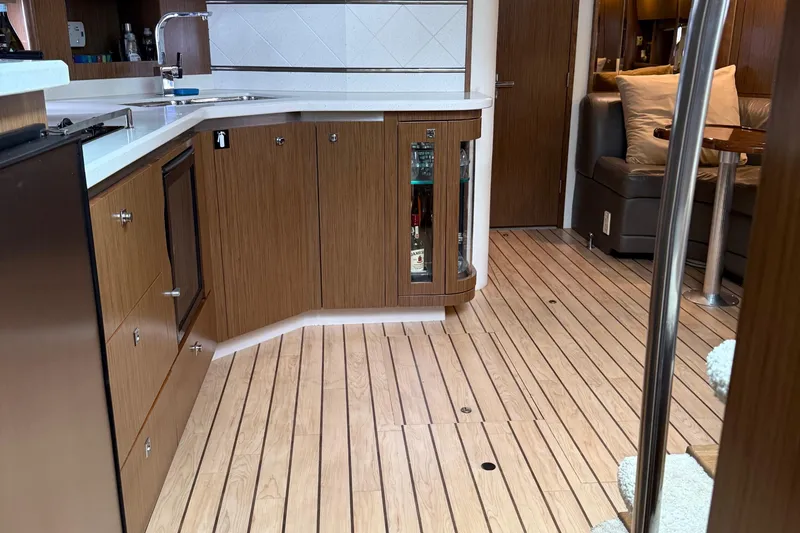 Slide: The Image of Luxurious interior of 2014 Cruisers Yachts 54 Sport Coupe with modern kitchen and seating area. - 42