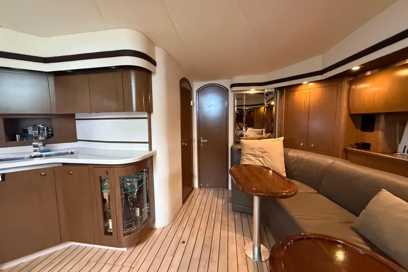 Slide: The Image of Luxurious interior of 2014 Cruisers Yachts 54 Sport Coupe with modern kitchen and seating area. - 54