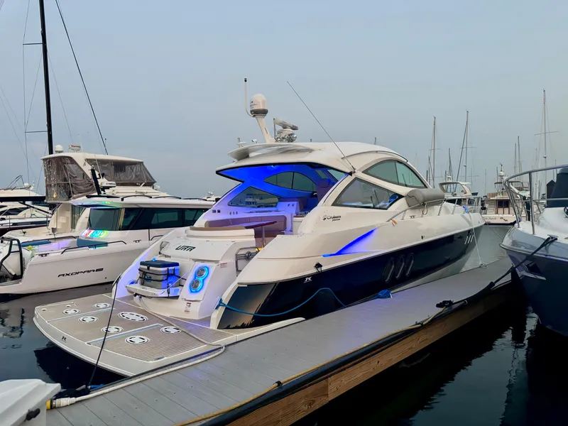 Slide: The Image of 2014 Cruisers Yachts 54 Sport Coupe docked at marina with blue accent lighting. - 6