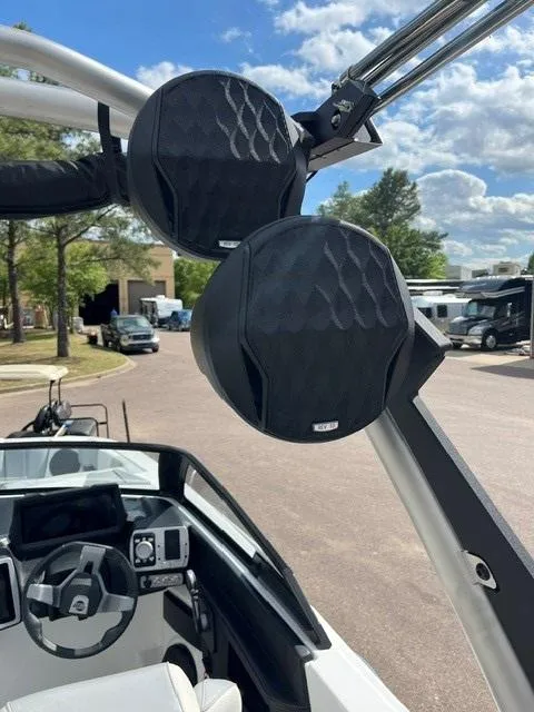 Slide: The Image of 2023 Malibu Wakesetter 24 MXZ boat with mounted speakers and modern dashboard. - 10