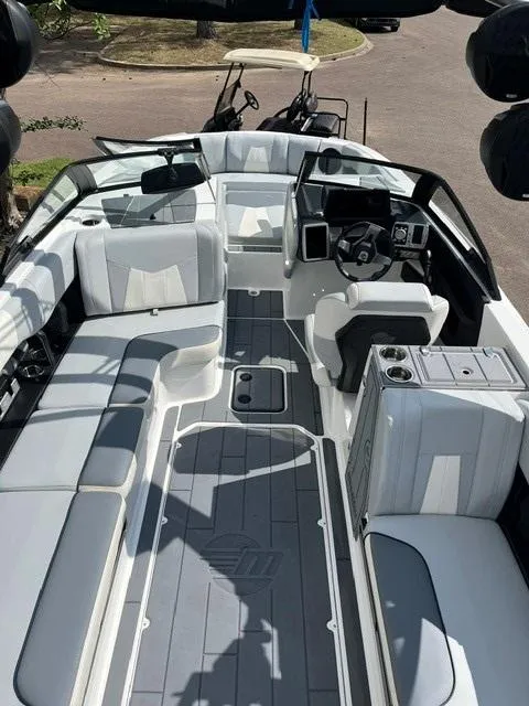Slide: The Image of 2023 Malibu Wakesetter 24 MXZ interior with sleek seating and modern dashboard design. - 12
