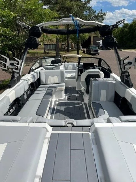 Slide: The Image of 2023 Malibu Wakesetter 24 MXZ boat interior with sleek seating and modern design. - 14
