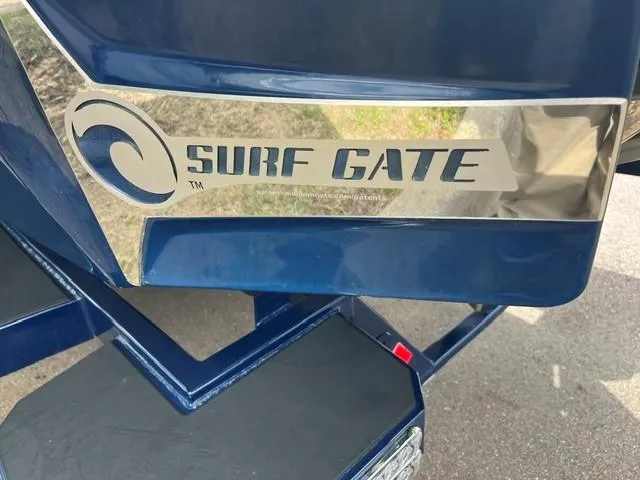 Slide: The Image of 2023 Malibu Wakesetter 24 MXZ with Surf Gate technology, blue exterior detail. - 17