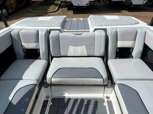 Slide: The Image of 2023 Malibu Wakesetter 24 MXZ interior with gray and white seating arrangement. - 18