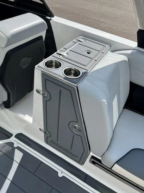 Slide: The Image of 2023 Malibu Wakesetter 24 MXZ interior with cup holders and storage compartment. - 7