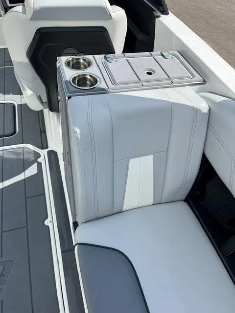 Slide: The Image of 2023 Malibu Wakesetter 24 MXZ interior with sleek seating and cup holders. - 8
