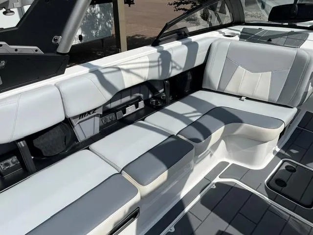Slide: The Image of 2023 Malibu Wakesetter 24 MXZ interior with sleek, modern seating and cup holders. - 9